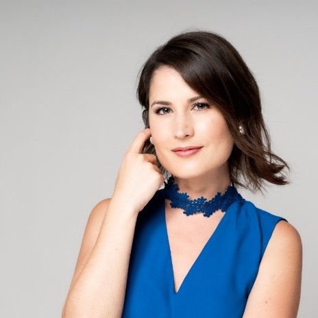 A person in a blue dress

Description automatically generated